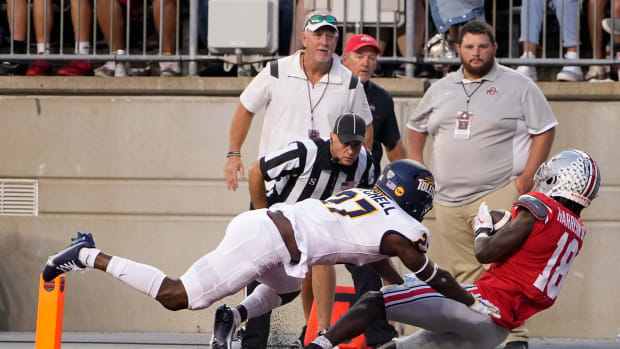 Sep 17, 2022; Columbus, Ohio, USA; Ohio State Buckeyes wide receiver Marvin Harrison Jr. (18) is hit by Toledo Rockets cornerback Quinyon Mitchell (27) as he catches a touchdown pass during the first half of the NCAA Division I football game at Ohio Stadium.